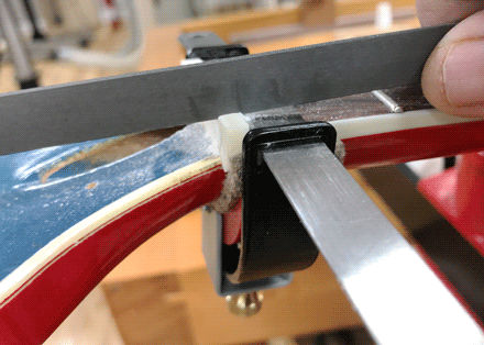 When the file reaches the feeler gauge, slot depth