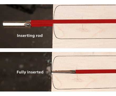 Sliding the truss rod into the end of the channel. 